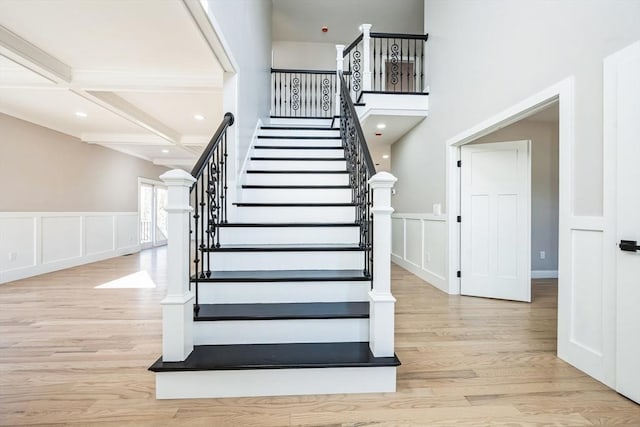 1 Falcon Dr, Shrewsbury, MA 01545 - stairway with wood finished floors, coffered ceiling, beam ceiling, a decorative wall, and wainscoting