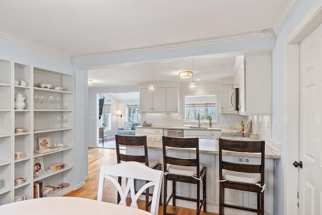 kitchen featuring sink, backsplash, stainless steel appliances, and white cabinets