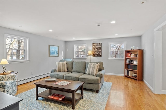 living room featuring a baseboard radiator and light hardwood / wood-style floors