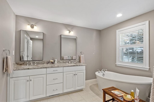 bathroom featuring a washtub and vanity