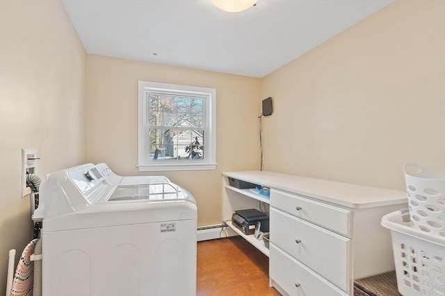 clothes washing area featuring a baseboard heating unit and independent washer and dryer