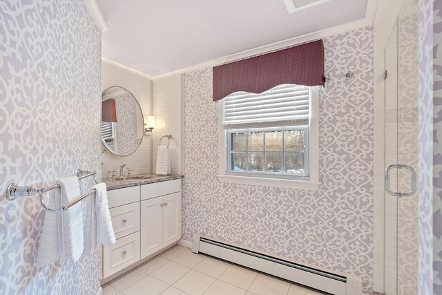 bathroom with tile patterned floors, crown molding, baseboard heating, vanity, and a shower with door