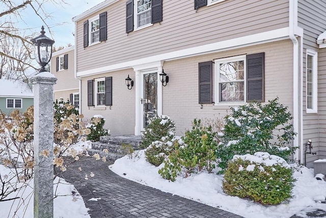 view of snow covered property entrance