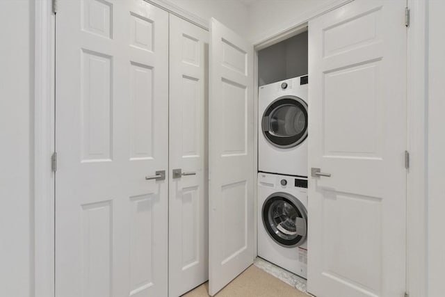 washroom featuring laundry area and stacked washer and dryer