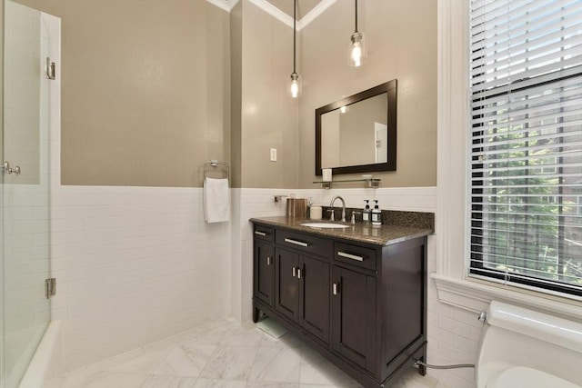 full bath featuring vanity, tile walls, toilet, and marble finish floor