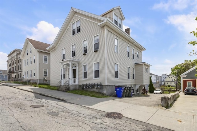 view of home's exterior with a residential view and a chimney