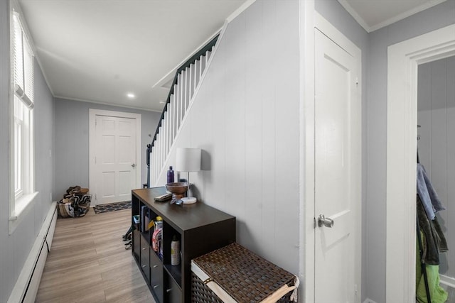 interior space featuring light wood-style floors, recessed lighting, a baseboard radiator, ornamental molding, and stairway