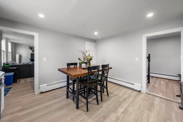 dining space featuring light wood-type flooring, a baseboard radiator, and recessed lighting