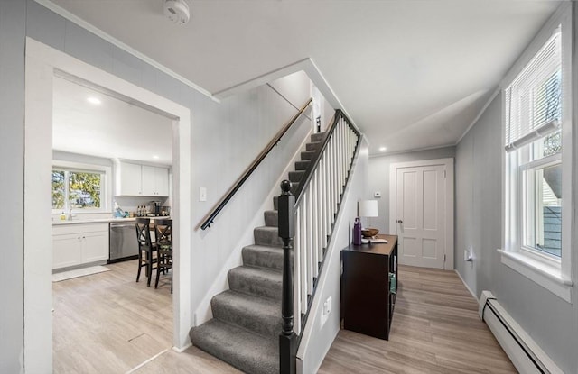 stairway featuring crown molding, recessed lighting, wood finished floors, and a baseboard radiator
