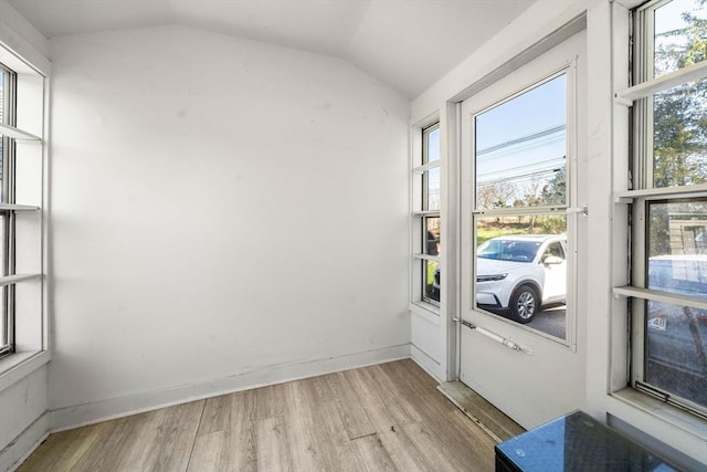 doorway with vaulted ceiling and wood finished floors