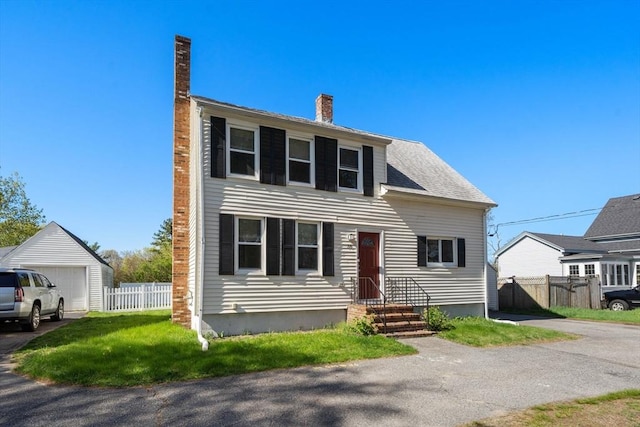 colonial-style house with fence and a chimney