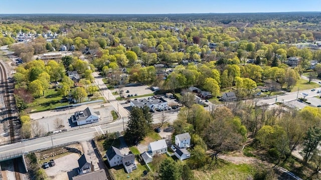 birds eye view of property featuring a view of trees