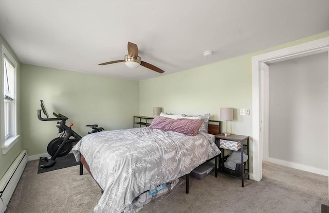 carpeted bedroom with baseboards, ceiling fan, baseboard heating, and multiple windows