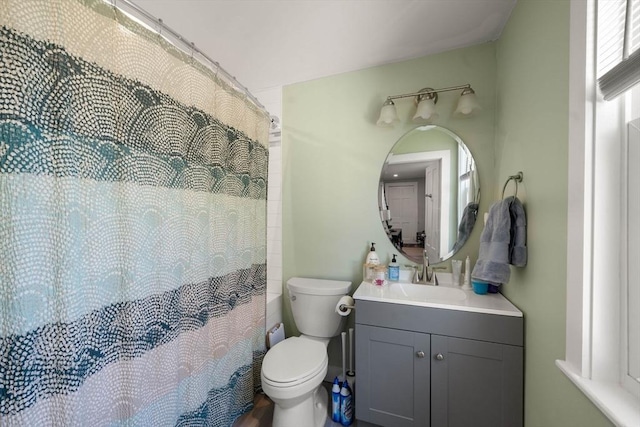 bathroom featuring vanity, toilet, and a shower with curtain