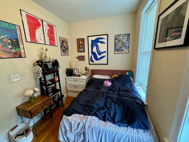 bedroom with dark hardwood / wood-style flooring