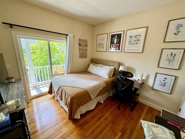 bedroom featuring access to exterior and wood-type flooring