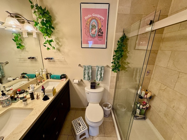 bathroom with tile patterned flooring, vanity, toilet, and a shower with door