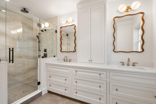 full bath with double vanity, a sink, and a shower stall