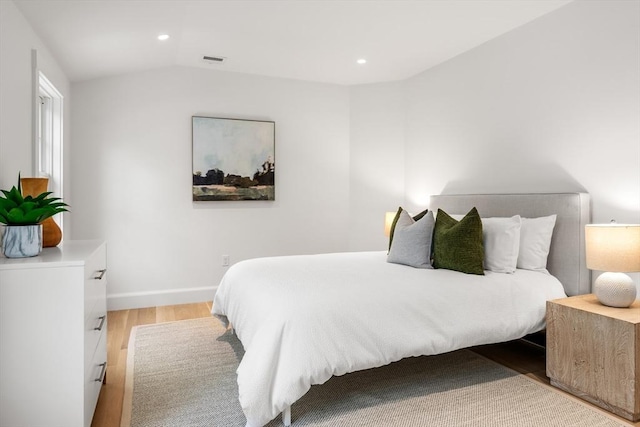 59 Mason Ter Unit 59, Brookline, MA 02446 - bedroom featuring wood finished floors, vaulted ceiling, recessed lighting, and baseboards