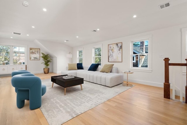 living area featuring plenty of natural light, wood finished floors, and visible vents