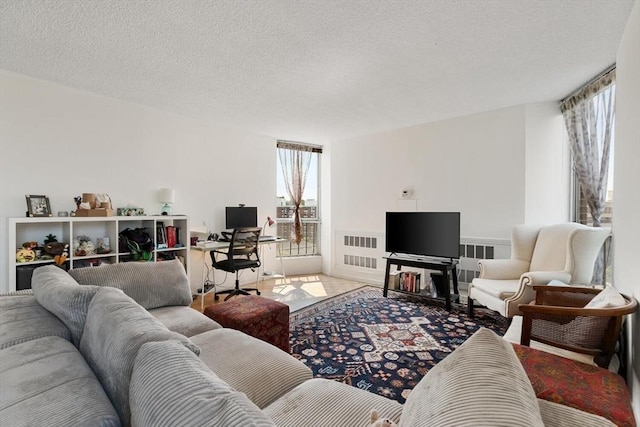 44 Washington St Unit 917, Brookline, MA 02445 - living room with radiator heating unit, a textured ceiling, and an office area