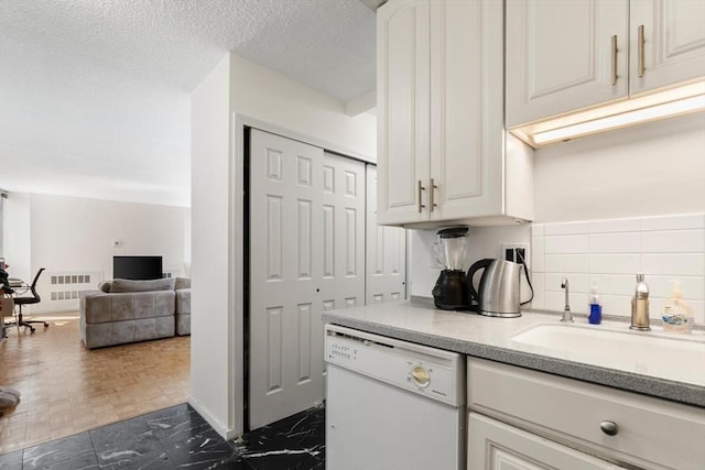 44 Washington St Unit 917, Brookline, MA 02445 - kitchen with dishwasher, light countertops, white cabinets, tasteful backsplash, and open floor plan