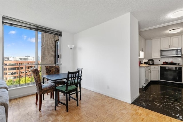 44 Washington St Unit 917, Brookline, MA 02445 - dining area featuring a textured ceiling and baseboards