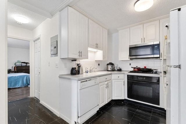 44 Washington St Unit 917, Brookline, MA 02445 - kitchen with stainless steel appliances, a textured ceiling, light countertops, white cabinetry, and backsplash