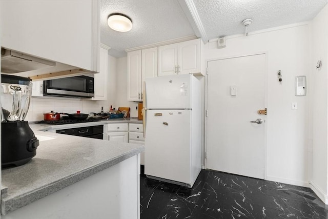 44 Washington St Unit 917, Brookline, MA 02445 - kitchen featuring freestanding refrigerator, dark marble finish flooring, stainless steel microwave, a textured ceiling, and white cabinets
