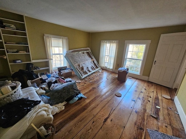 unfurnished bedroom with hardwood / wood-style floors and a textured ceiling