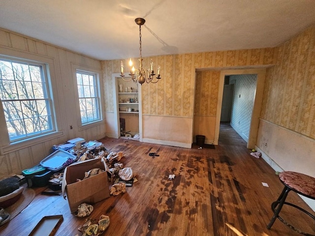 unfurnished dining area featuring dark hardwood / wood-style flooring and a notable chandelier