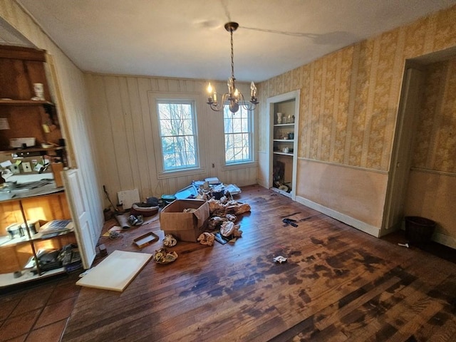 dining space featuring a notable chandelier and dark hardwood / wood-style floors