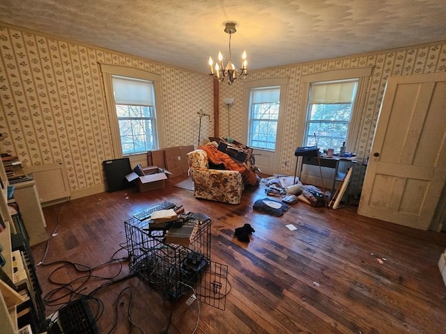 interior space featuring dark wood-type flooring, a textured ceiling, and a notable chandelier