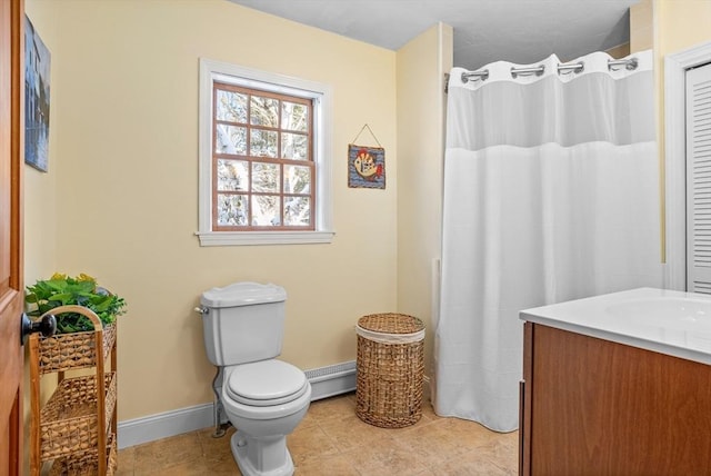 bathroom with vanity, toilet, tile patterned flooring, and a baseboard heating unit