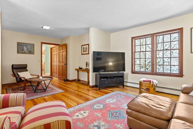 living room featuring a baseboard heating unit and light hardwood / wood-style floors