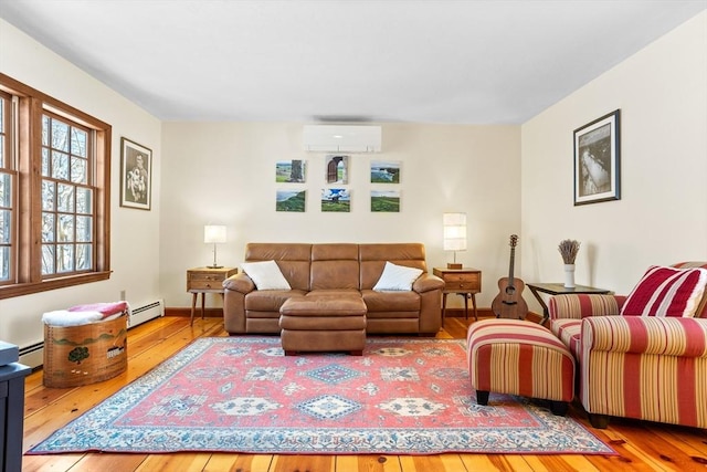 living room with a baseboard radiator, hardwood / wood-style floors, and an AC wall unit