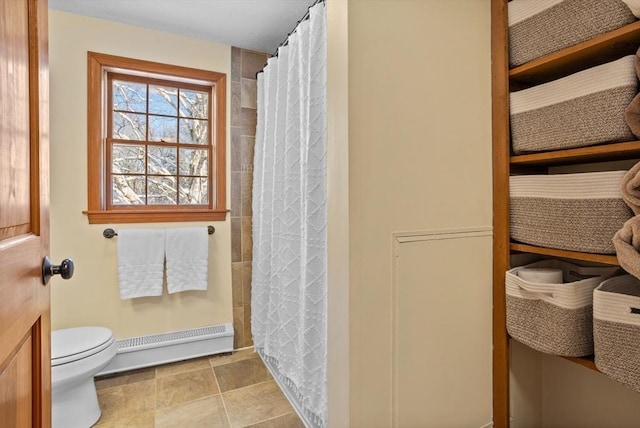 bathroom with a baseboard heating unit, a shower with curtain, and toilet