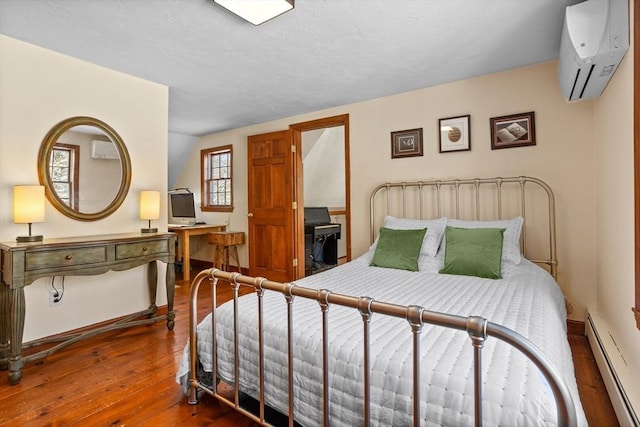 bedroom with baseboard heating, a wall mounted air conditioner, vaulted ceiling, and dark wood-type flooring