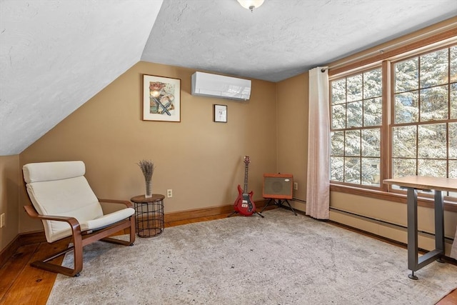 sitting room featuring lofted ceiling, a wall mounted AC, and a textured ceiling