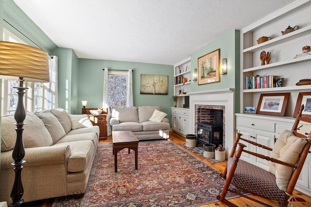 living room with hardwood / wood-style floors and built in features