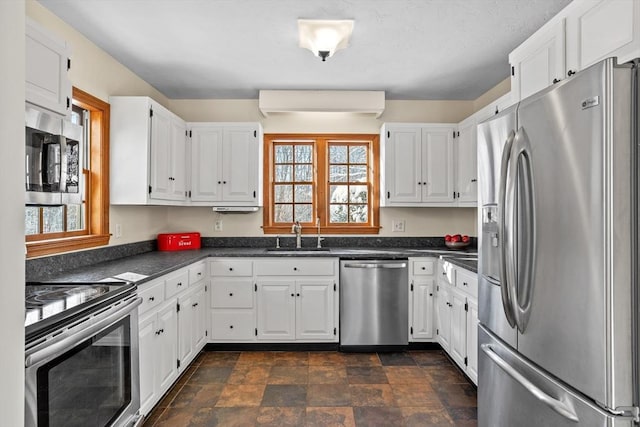 kitchen with white cabinetry, appliances with stainless steel finishes, sink, and plenty of natural light