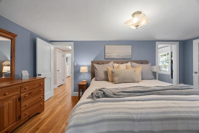 bedroom featuring baseboards and light wood-style floors