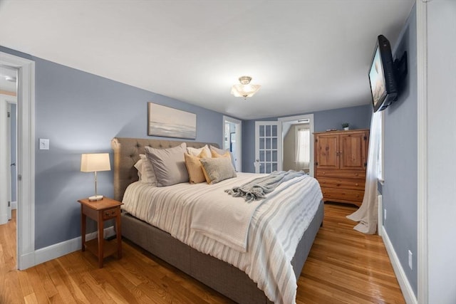 bedroom featuring baseboards and wood finished floors