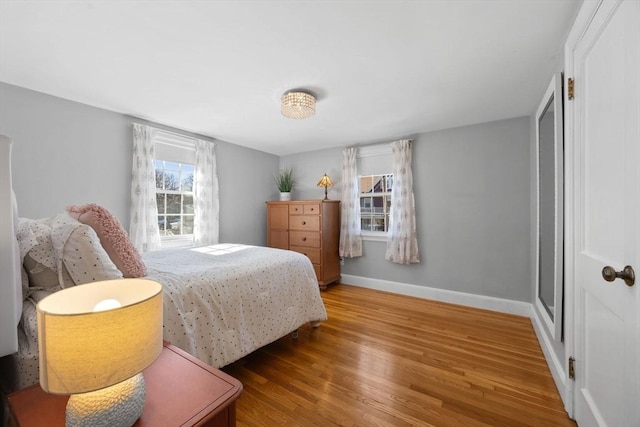 bedroom featuring baseboards and wood finished floors