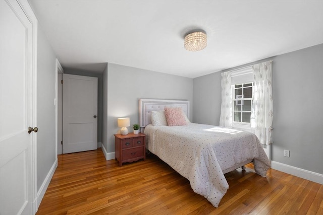 bedroom featuring baseboards and hardwood / wood-style floors