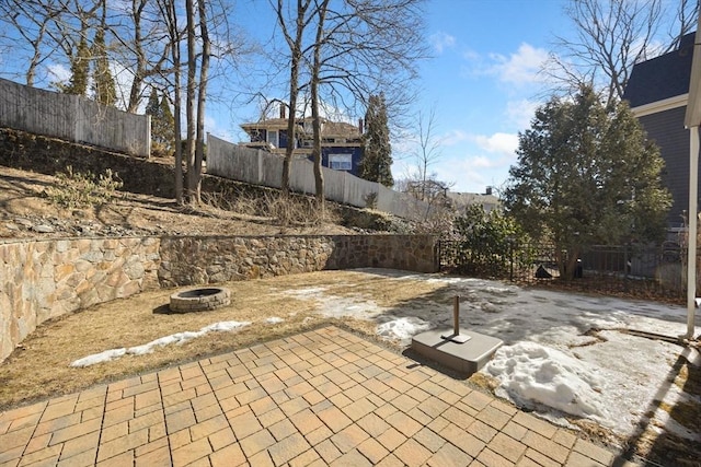 view of patio with a fenced backyard and a fire pit