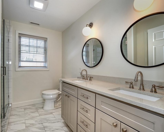 bathroom featuring toilet, visible vents, marble finish floor, and a sink