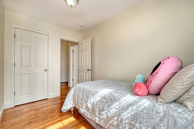 bedroom with baseboards and light wood-style floors