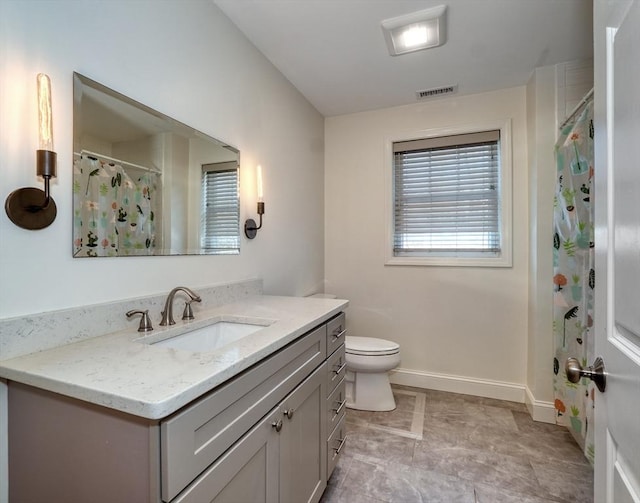 bathroom with visible vents, toilet, a shower with curtain, baseboards, and vanity