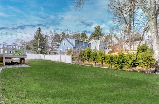 view of yard with a wooden deck and fence